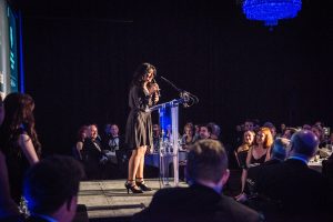 Shappi Khorsandi entertaining guests in the Banqueting Hall during an Awards Dinner at Glaziers Hall